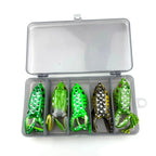 Set of five green frog-shaped fishing lures in a clear box on a white background