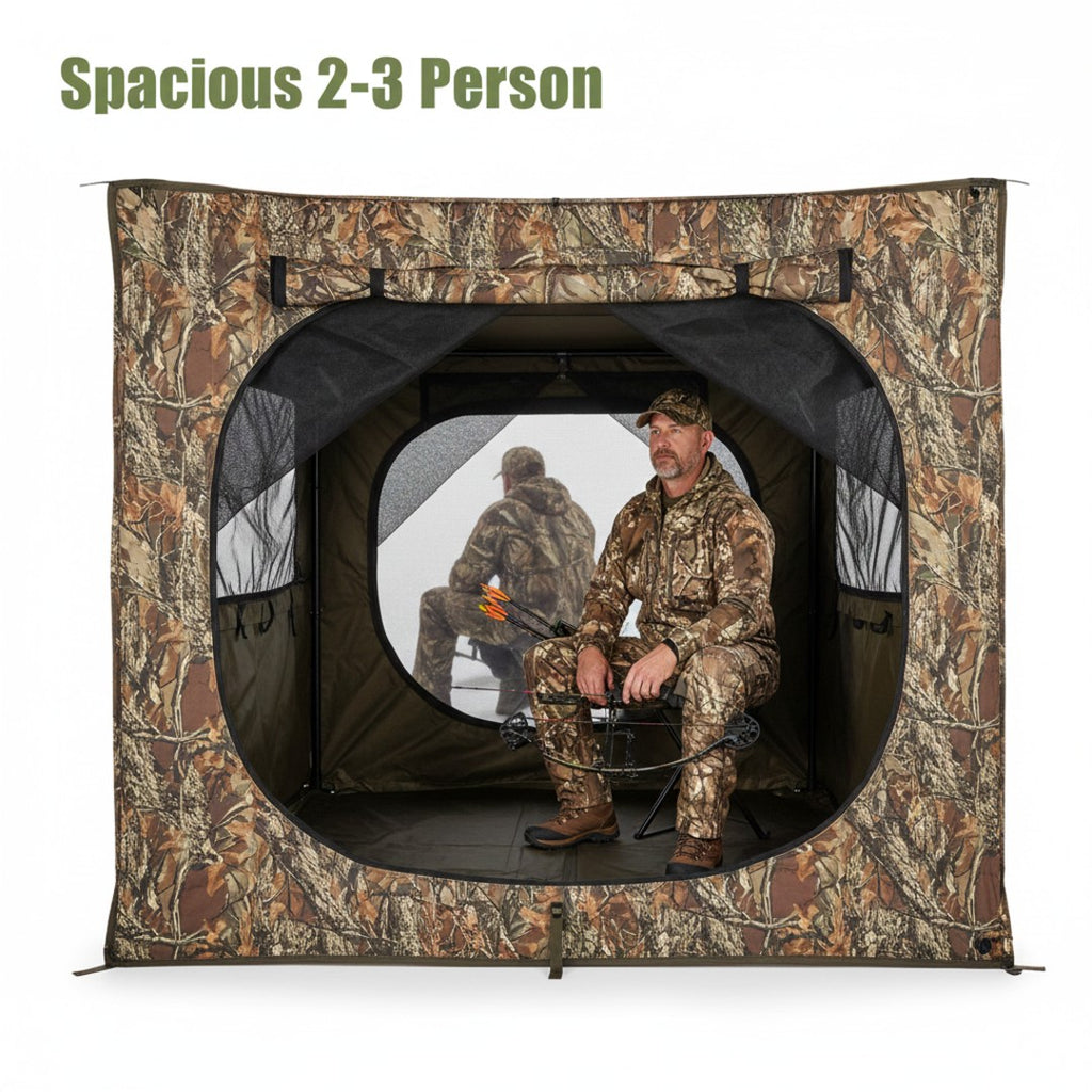 Interior view of the NEXTBAIT VS270 hunting blind, showing a hunter seated comfortably with a bow, demonstrating spacious room for 2-3 people and gear. Reflective window shows exterior view.